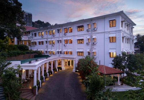 a large white building with a walkway at Hotel Suisse Kandy - Since 1890 in Kandy