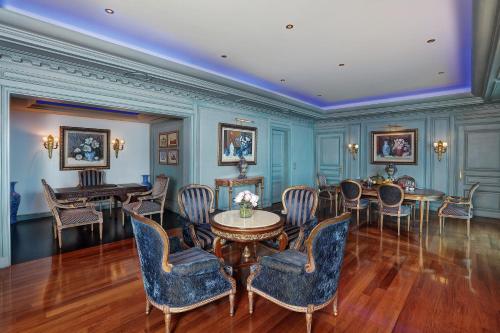 a room with blue walls and a table and chairs at Le Royal Hotel - Beirut in Beirut