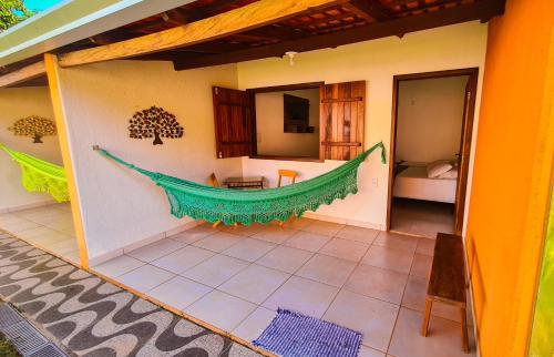 a room with a hammock on the side of a house at POUSADA MANACÁ DA SERRA in Vargem Bonita