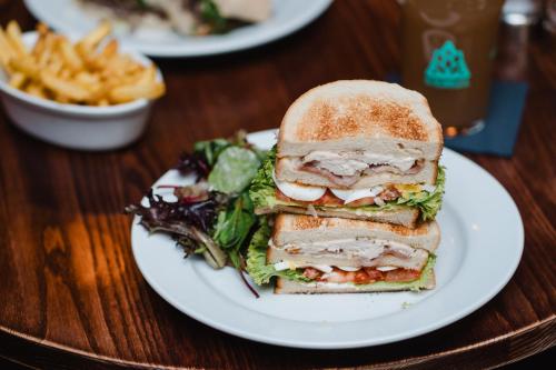 a sandwich on a plate with a salad and fries at The Royal Sutton in Sutton Coldfield