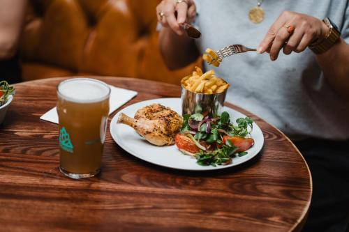 a table with a plate of food and a drink at The Royal Sutton in Sutton Coldfield