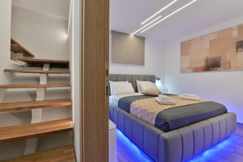 a bedroom with a bed and a staircase at September15 Suites- Meganisi in Meganisi