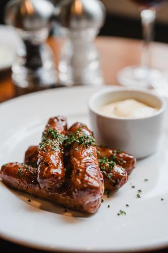 a plate of food with meat and sauce on a table at The Royal Sutton in Sutton Coldfield