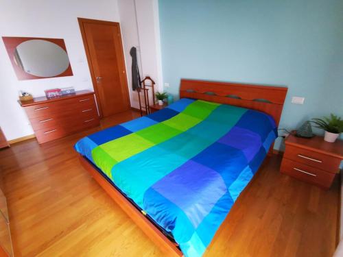 a bedroom with a large bed with a colorful blanket at Your retreat in Mestre - Venezia comoda a due passi in Venice