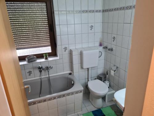 a bathroom with a tub and a toilet and a sink at AS Apartment Neukirchen-Vluyn in Neukirchen-Vluyn