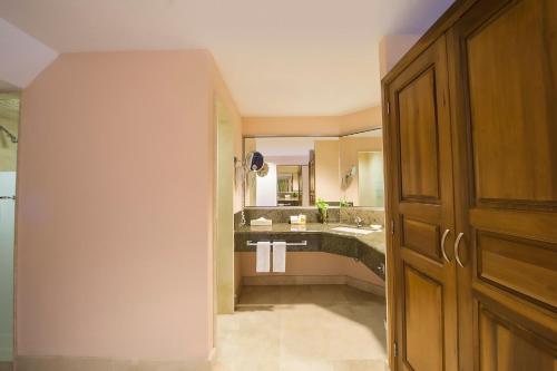 a bathroom with a sink and a large mirror at Fiesta Americana Puerto Vallarta All Inclusive & Spa in Puerto Vallarta