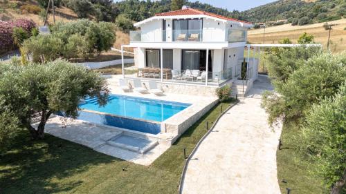 an aerial view of a house with a swimming pool at Daroma Villa, Paliouri by Halkidiki Villas in Paliouri