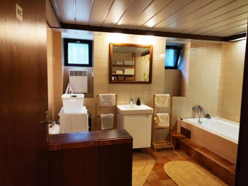 a bathroom with a tub and a toilet and a sink at Garden Apartment in Brno