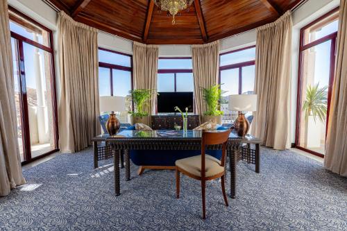 a large living room with a table and a couch at Mövenpick Resort Petra in Wadi Musa