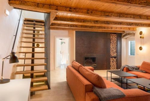 a living room with a couch and a fireplace at Villa Irma in Pitve