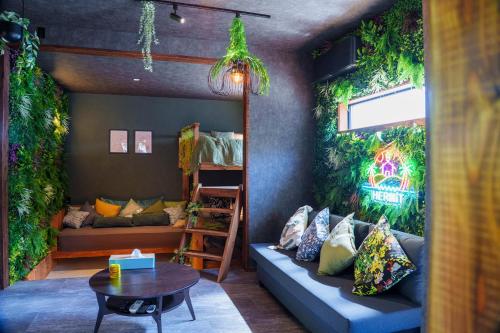 a living room with a couch and a table at 100度越えサウナ,森林浴,絶景パノラマビュー,森の中の隠れ家,星見ジャグジー---ハーミットたいとう--- in Shiigi
