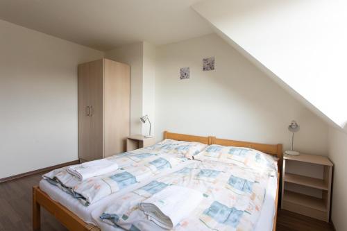a bedroom with a bed in a attic at Apartmány pod Zakletým - Hotel Říčky in Říčky