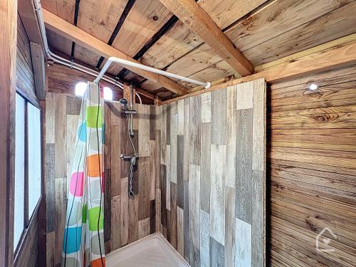a bathroom with a shower and a shower curtain at Yourte nature & calme proche Futuroscope in Archigny