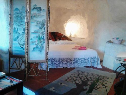 a bedroom with a bed in a room with smoke coming out at Casa Sulla Rupe in Calcata