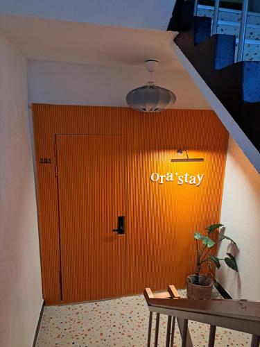 an orange door with an off stay sign on it at Ora Stay Anyang in Anyang