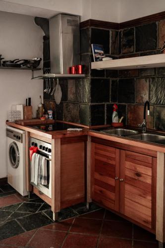 a kitchen with a sink and a stove top oven at Roditses Beach Sea Front Apartments in Samos