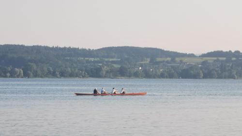 a group of people in a boat on a lake at Löwenhof Jurte in Wald