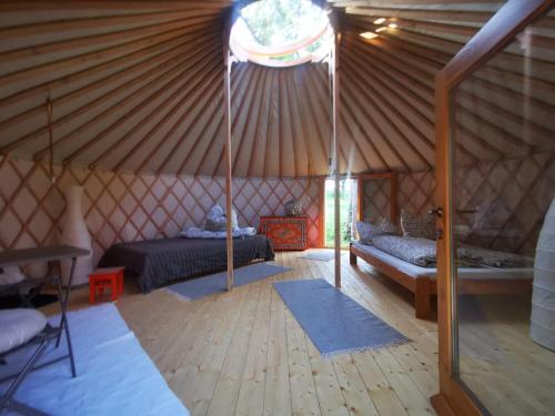 a room with a bed and a couch in a yurt at Löwenhof Jurte in Wald
