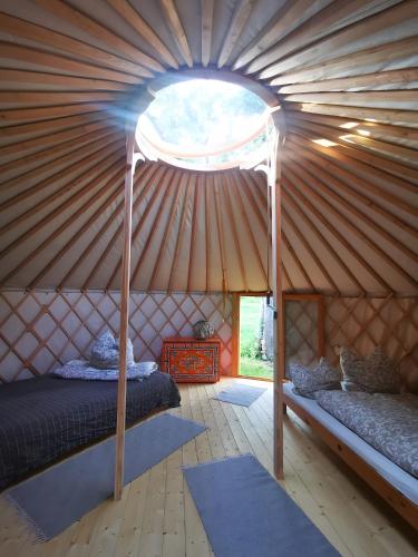a room with two beds in a yurt at Löwenhof Jurte in Wald