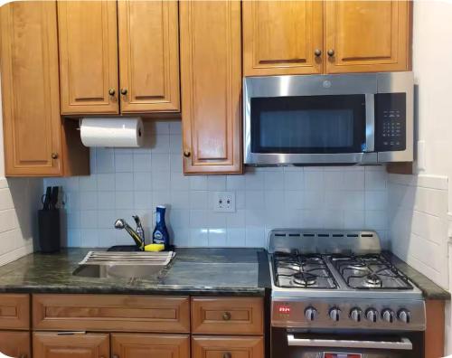 a kitchen with a stove and a microwave at 10 Min to NYC Quiet 1BR Flash Deal June 22 to 25 in Weehawken