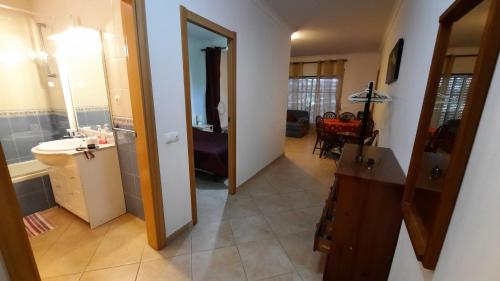 a bathroom with a sink and a mirror in a room at St James Apartment in Luz