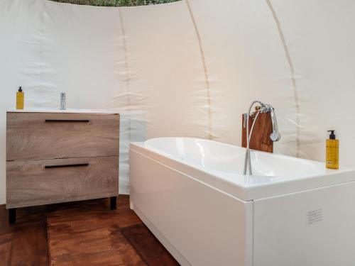 a bathroom with a white tub and a sink at Tenuta Lu Baroni in Porto Ottiolu