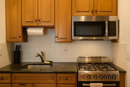 a kitchen with a stove and a microwave at 10 Min to NYC Quiet 1BR Flash Deal June 22 to 25 in Weehawken
