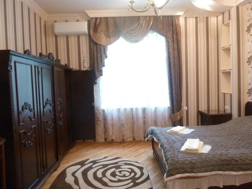 a bedroom with a bed and a large window at Zekorei Guest House in Kutaisi