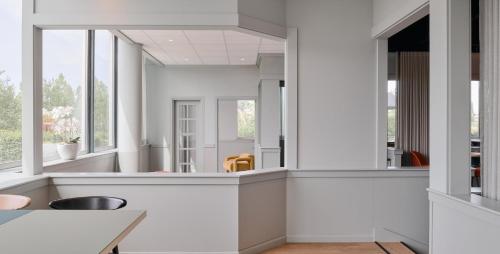 a kitchen with white walls and windows at Garner Hotel Maastricht by IHG in Maastricht