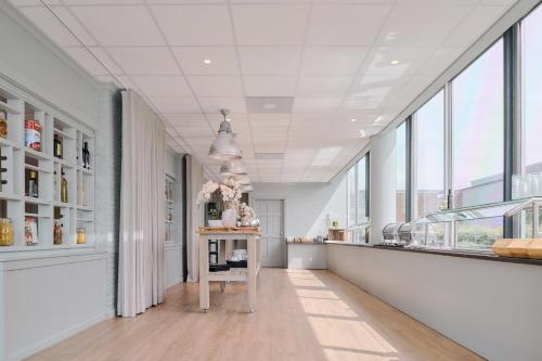 a room with a counter and some windows at Garner Hotel Maastricht by IHG in Maastricht