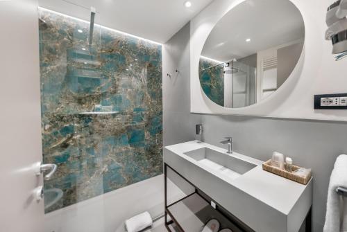 a bathroom with a sink and a mirror at Abacus Hotel in Sesto San Giovanni