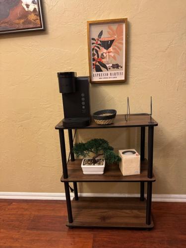 a shelf in a room with a picture on the wall at Home in Moore Serenity Oasis! relax in style! in Moore