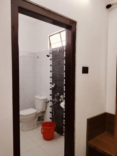 a bathroom with a toilet and a shower at RKs HOME STAY in Shillong