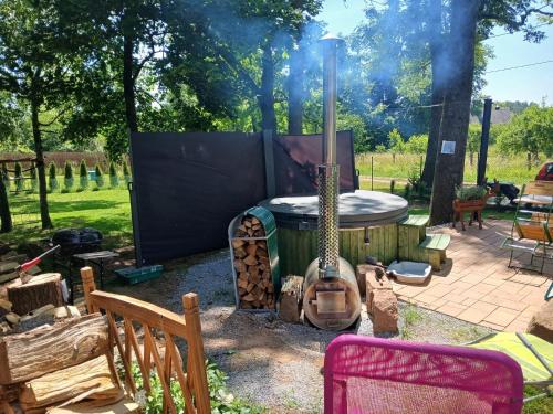 a backyard with a fire pit and a guitar at NEW! Tiny house U Jelena, hot tub in Trutnov