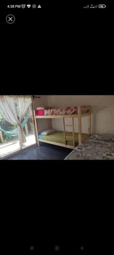 a bedroom with two bunk beds and a window at Surf homes in La Floresta