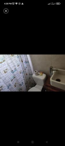 a bathroom with a toilet and a sink at Surf homes in La Floresta