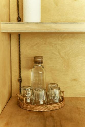 a glass jar on a shelf with three tea glasses at Pana Ayusai in Almaty