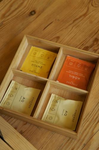a wooden box with nine books on a wooden floor at Pana Ayusai in Almaty