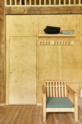 a wooden bench sitting in front of a wooden wall at Pana Ayusai in Almaty