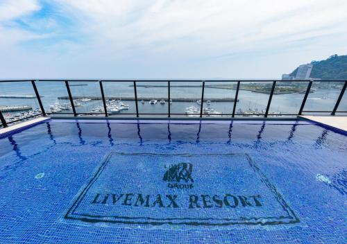 a swimming pool on the roof of a luxury resort at LiVEMAX RESORT Atami Sea Front in Atami