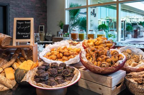 a display of different types of bread and pastries at Radisson Resort Ras Al Khaimah Marjan Island in Ras al Khaimah