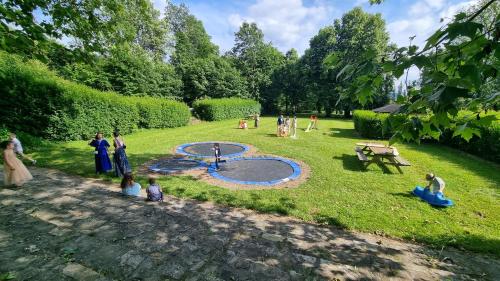 a group of people standing around a park with a playground at Chateau de l Aviette - Rancennes in Givet