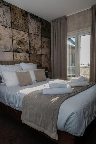En eller flere senge i et værelse på Le Grand Hôtel de la Marine "face à la mer"