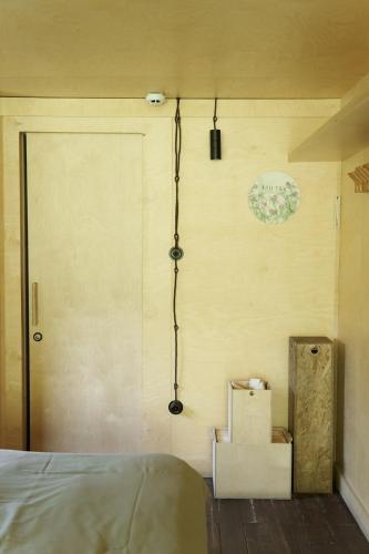 a room with a door with boxes and a clock on the wall at Pana Ayusai in Almaty