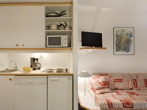 - une petite cuisine avec un lit et un four micro-ondes dans l'établissement Studio cabine fonctionnel, accès direct pistes, balcon - FR-1-181-2244, à La Plagne Tarentaise