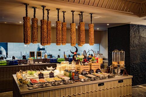 a buffet line with food on display in a restaurant at Grand Mirage Dhanbad, a member of Radisson Individuals in Dhanbād