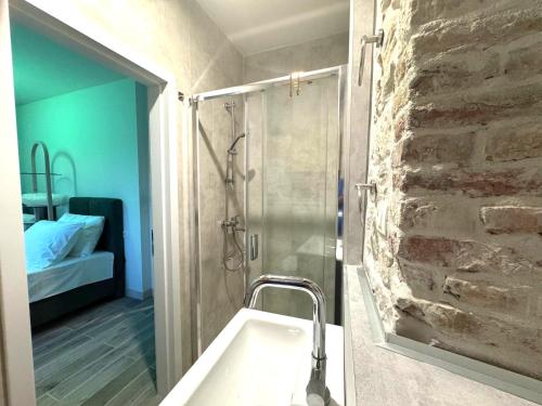 a bathroom with a shower with a sink and a sink at Rooms Malo more Trogir in Trogir