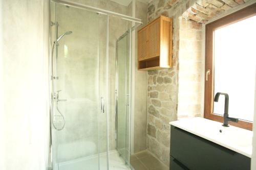 a bathroom with a glass shower and a sink at Rooms Malo more Trogir in Trogir