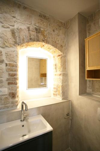 a bathroom with a sink and a window at Rooms Malo more Trogir in Trogir