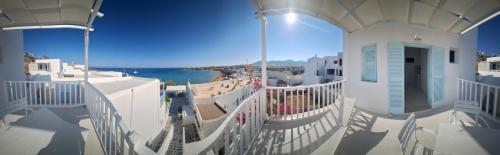 a balcony of a building with a view of the ocean at Paros Carmel studio-apartment in Logaras